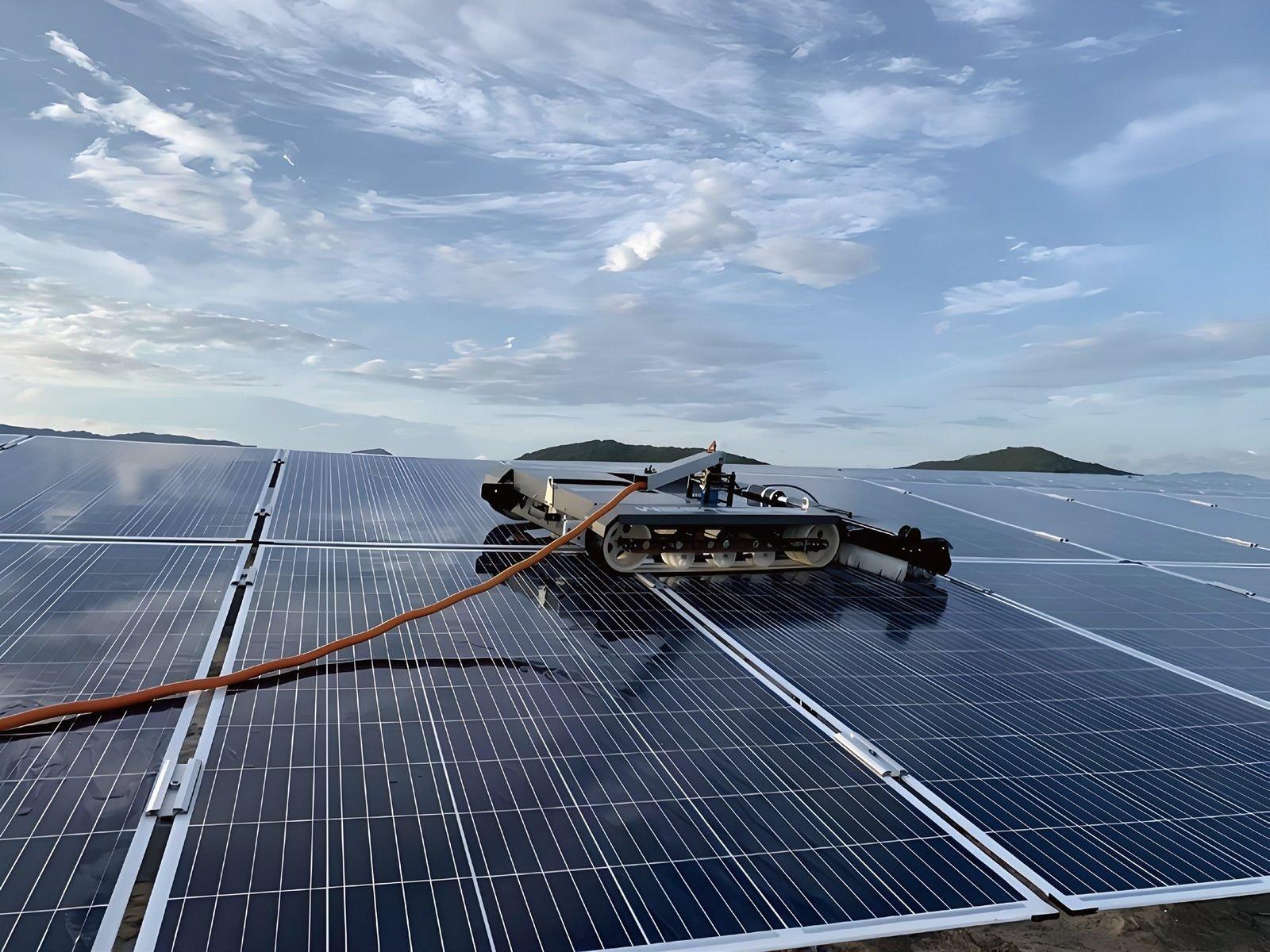 Photovoltaic panel cleaning robot on a solar array